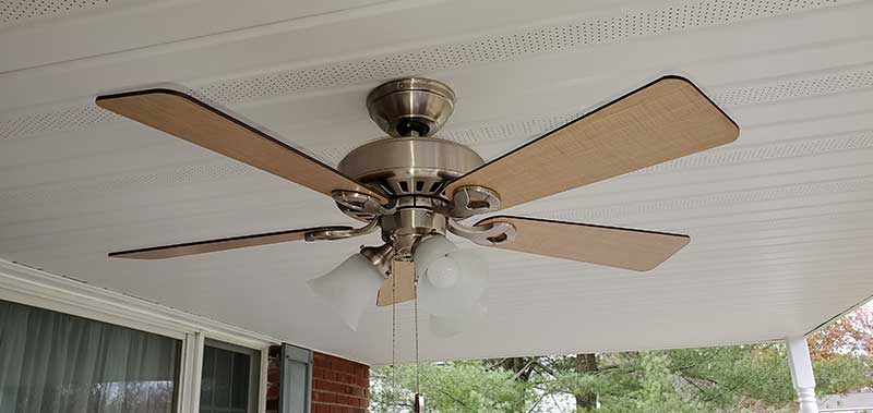Ceiling fan installation with wooden blades and light fixtures, showcasing residential electrical work by Nalset Electrical Services.
