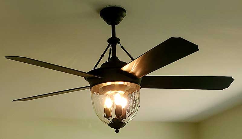 Ceiling fan installation with four blades and a glass light fixture, showcasing residential electrical work by Nalset Electrical Services.