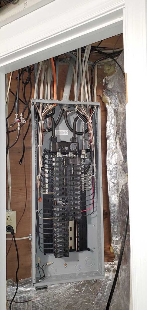 Main electrical panel installation with multiple circuit breakers and wiring in a residential setting, showcasing Nalset Electrical Services' expertise in electrical upgrades.