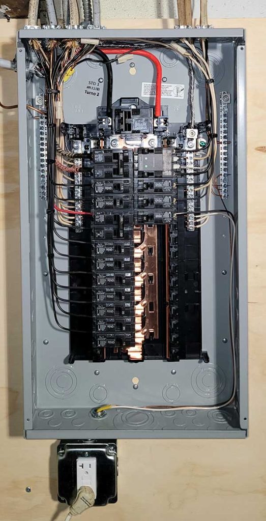 Main electrical panel installation showcasing circuit breakers, wiring, and a disconnect box, illustrating quality electrical service upgrades by Nalset Electrical Services.
