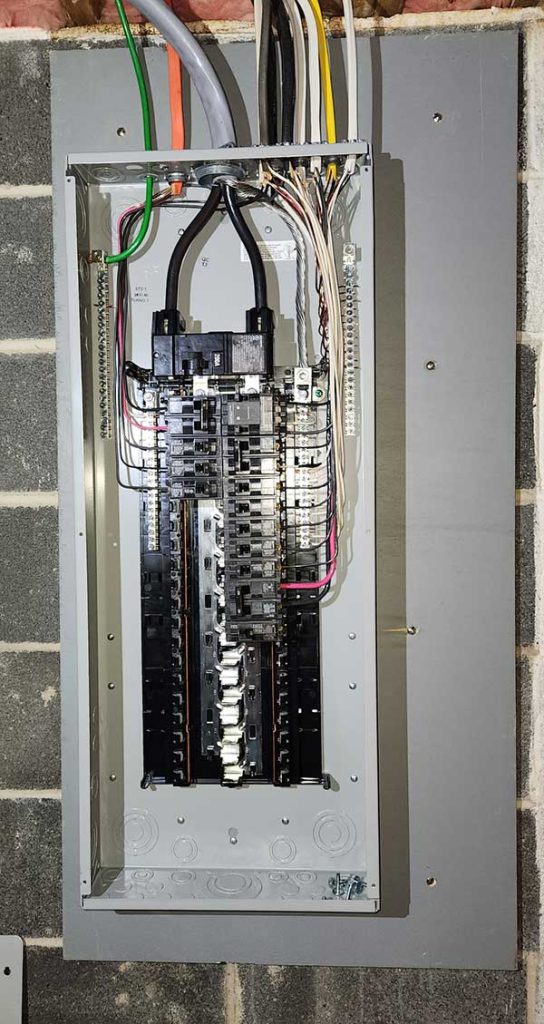 Main electrical panel installation showcasing circuit breakers and wiring in a residential setting.