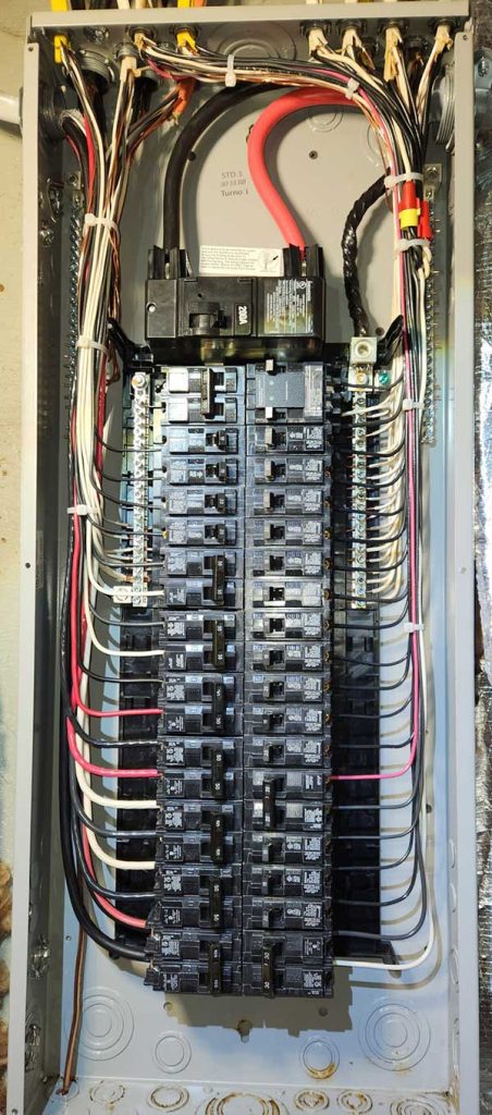 Main electrical panel installation showcasing multiple circuit breakers and organized wiring, illustrating Nalset Electrical Services' expertise in residential electrical upgrades.