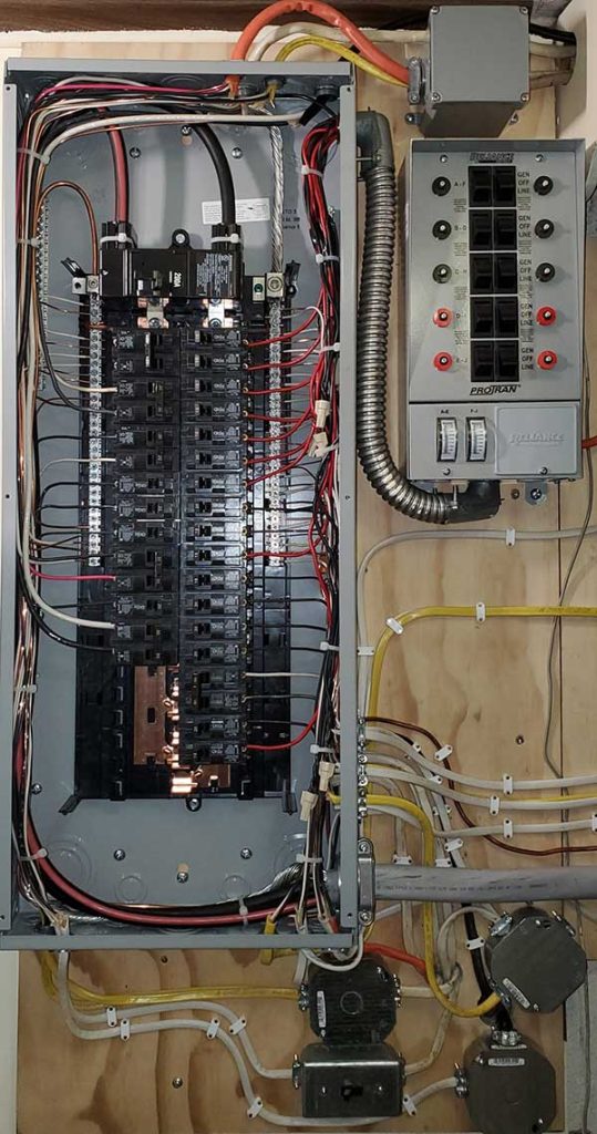 Main electrical panel installation with multiple circuit breakers, wiring, and a disconnect box, showcasing Nalset Electrical Services' expertise in electrical upgrades.