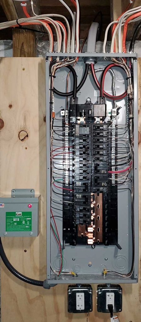 Main electrical panel installation showcasing circuit breakers, wiring, and a disconnect box, emphasizing Nalset Electrical Services' expertise in residential electrical upgrades.