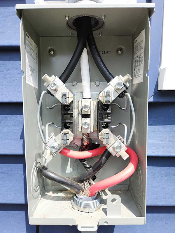 Electrical meter base installation showcasing wiring connections and components, emphasizing residential electrical service upgrades by Nalset Electrical Services.