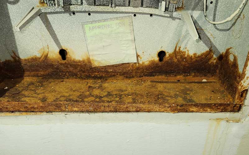 Rusty electrical panel with visible corrosion and deterioration, highlighting unsafe electrical conditions related to electrical safety inspections.